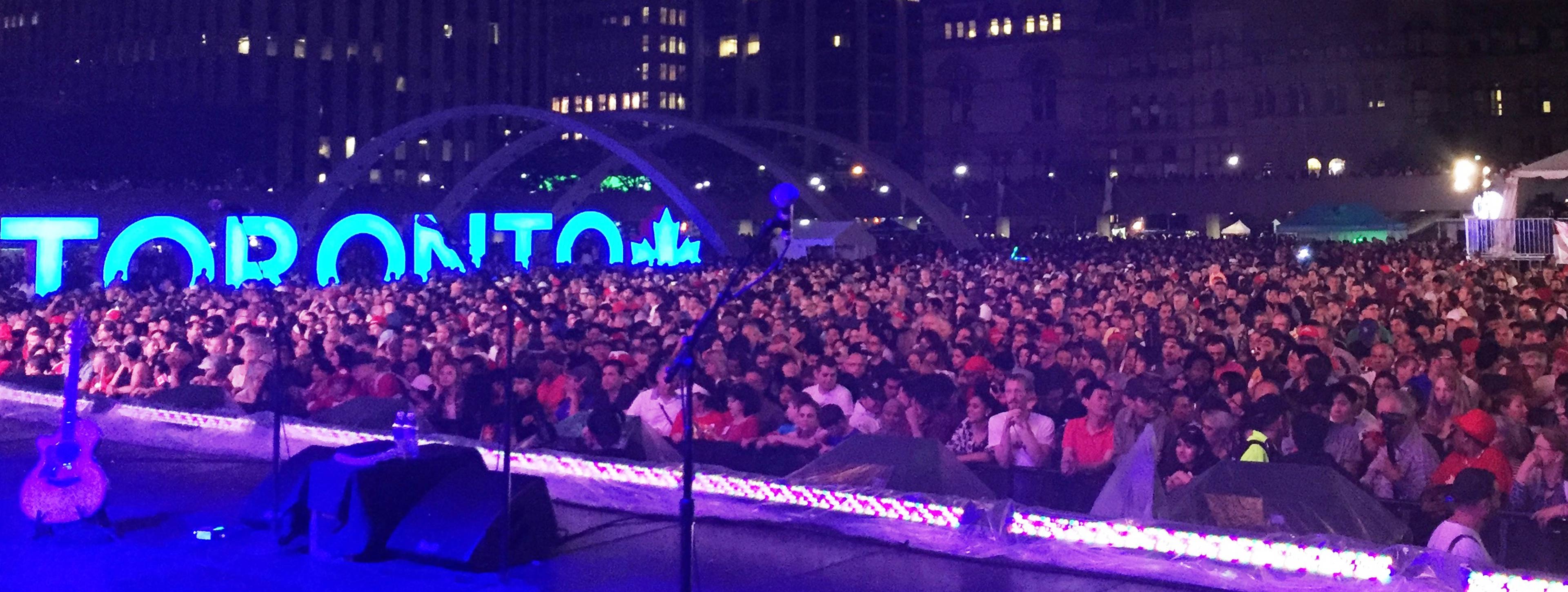 A crowd attending an outdoor concert in Toronto on Canada Day. 