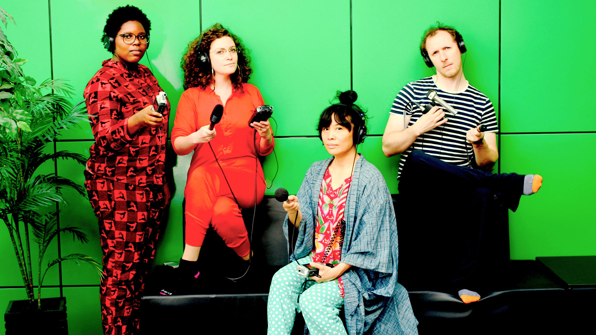 Three women and a man are holding voice recorders.